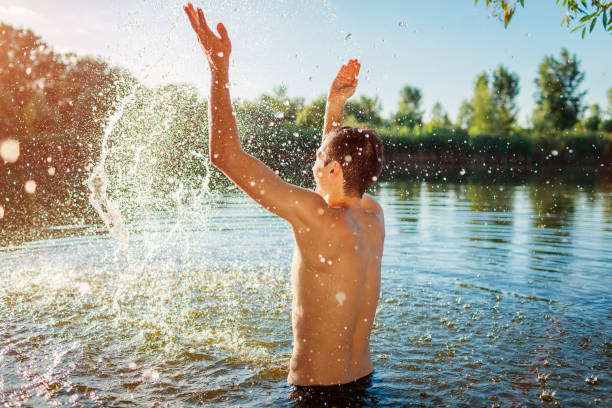 istock Young man in water and making splash. Summer vacation 1158182092