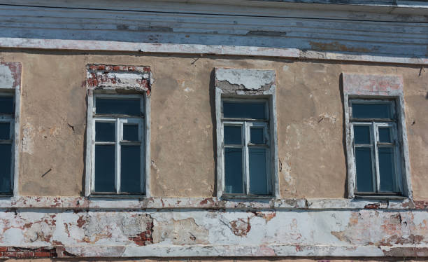 istock four windows in an old brown brick wall with broken plaster 1158182540