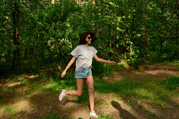 istock Young woman dancing near grove 1158183497