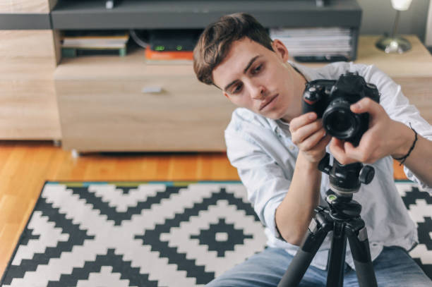 istock Young male vlogger adjusting his gear 1158183673