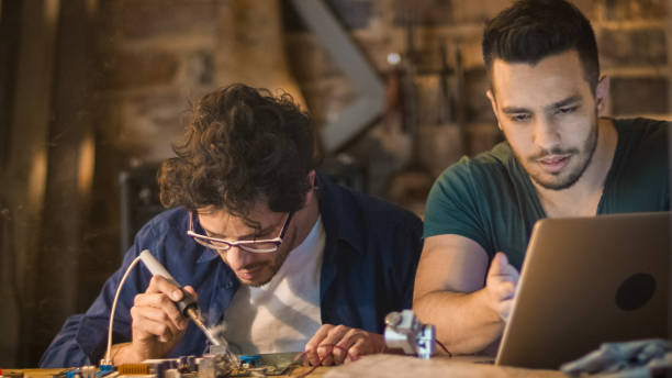 istock Two students are studying electronics and soldering in a garage. 1158183703