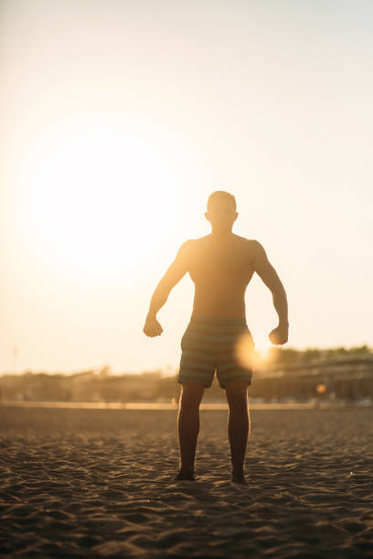 istock Silhouette of handsome man on the beach. sunset 1158185041