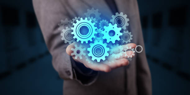 istock Hand holding gears in his hand 1158185308