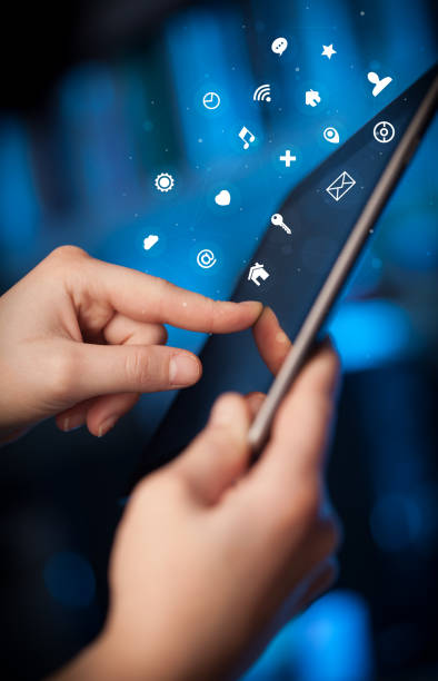 istock Hand holding tablet with application icons concept 1158185325
