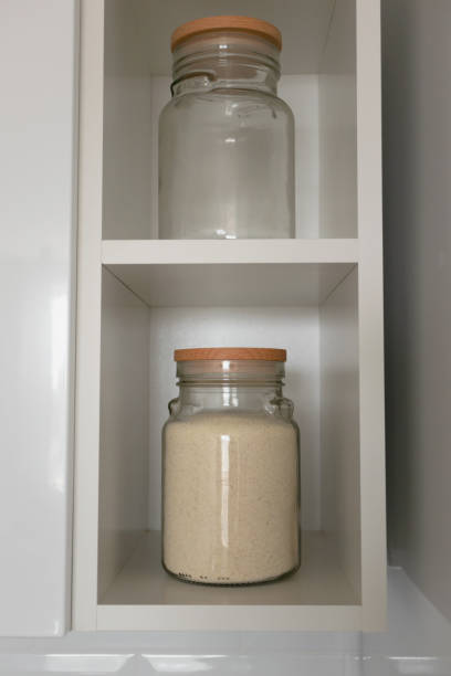 istock Kitchenware. Glass jar with semolina and wooden lid 1158186515