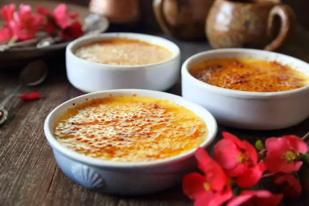 Creme brulee, french traditional dessert, three portions. Rustic style