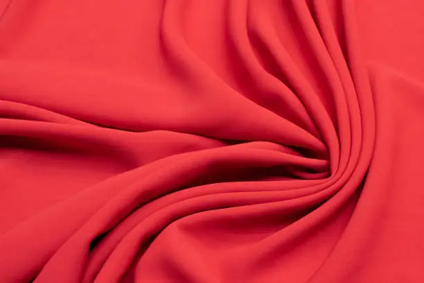Fabric viscose (rayon). Color red-orange. Texture, background, pattern.