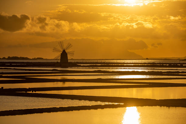istock Marsala salt pans at sunset, Sicily, Italy 1158189998