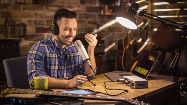 istock Young man makes a podcast audio recording at home in a garage. 1158190023