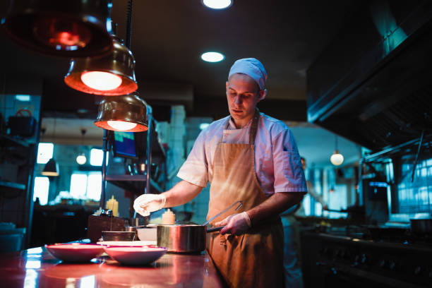 istock Chef cooking in the modern kitchen in a high-end restaurant 1158191312