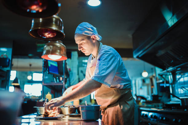istock Chef cooking in the modern kitchen in a high-end restaurant 1158191329