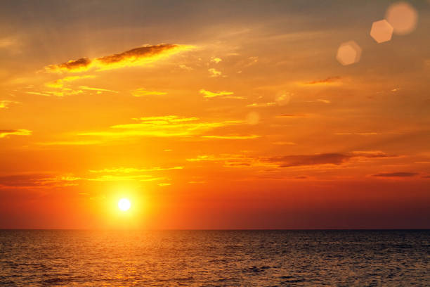 istock beautiful bright sunset over the sea with clouds in the sky 1158191940