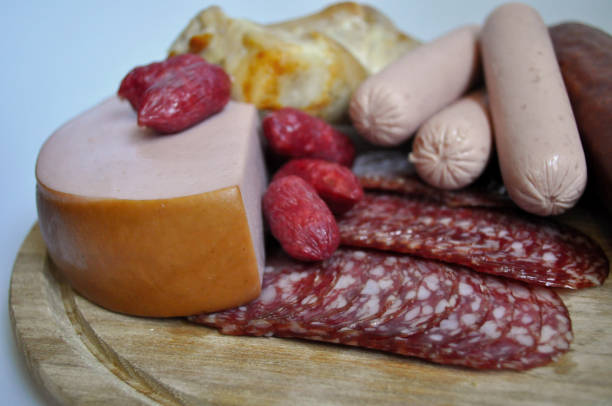 meat and sausages on wooden background