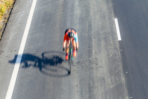 Cycling Cyclist road race riding overhead photo of motion speed blur action.