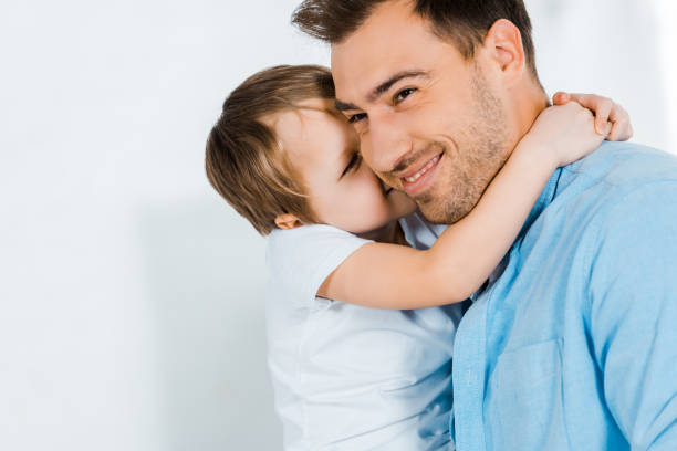 istock smiling father hugging adorable preschooler son at home with copy space 1158192920