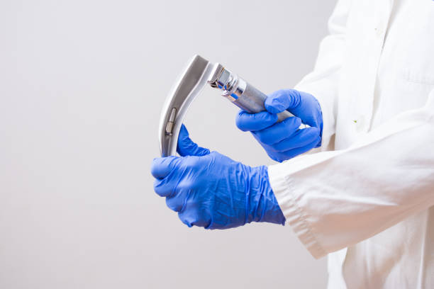 hand's doctor holding laryngoscope, isolated on white background, copy space - blade of grass grass isolated white imagens e fotografias de stock