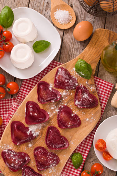 istock Red heart ravioli with tomato, mozzarella and basil. 1158193544