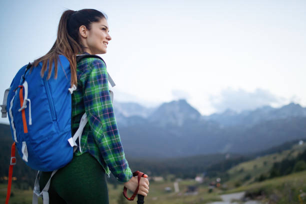 istock Hiker with backpack relaxing on top of a mountain and enjoying valley view 1158194719