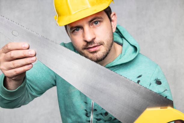 the construction worker shows a new saw to cut, close up