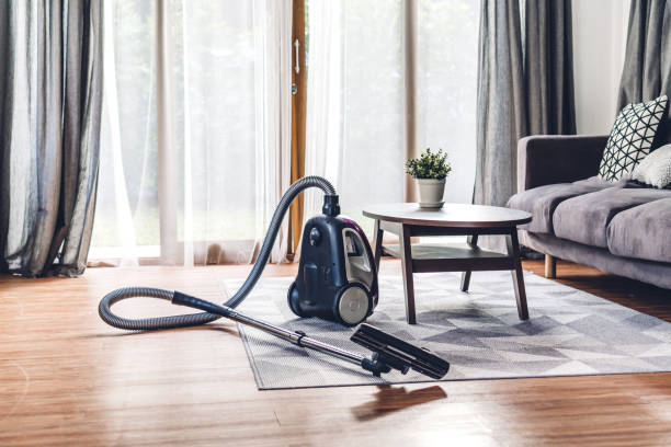 Vacuum cleaner in living room at home stock photo