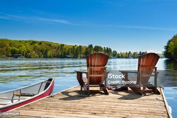 Muskoka Chairs On A Wooden Dock Stock Photo - Download Image Now - Lake, Summer, Vacations