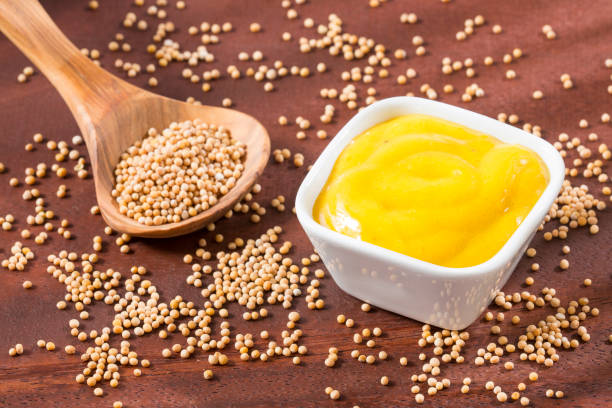 istock Mustard with seeds on the wooden background. 1158196234