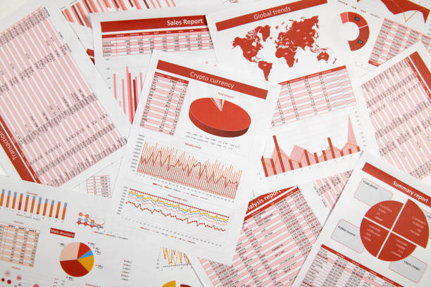 istock Business reports, data tables and charts - directly above view of office table workspace. 1158197421