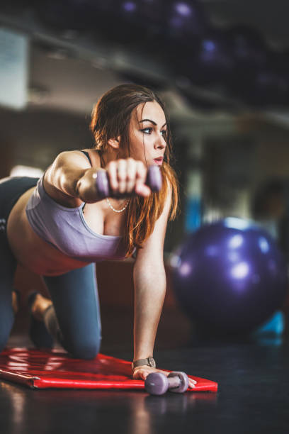 istock Pregnant young woman exercising on  mat in studio 1158197583