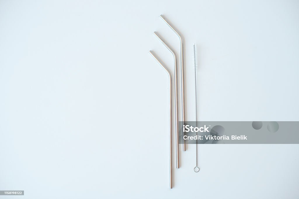 Lot of metal tubes for cocktails with schutkoy for cleaning isolated on white. Lot of metal tubes for cocktails with schutkoy for cleaning isolated on white Aluminum Stock Photo