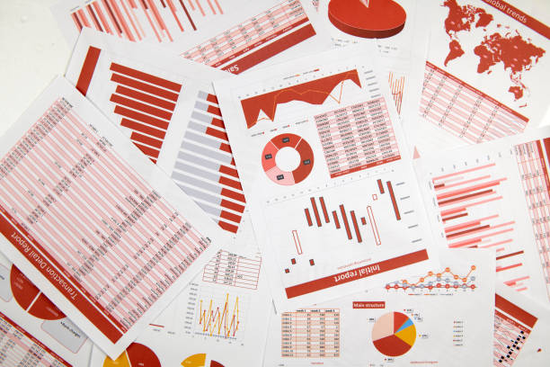 istock Business reports, data tables and charts - directly above view of office table workspace. 1158198779