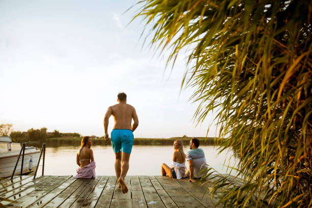 istock Young people having fun at the lake on a summer day 1158198844