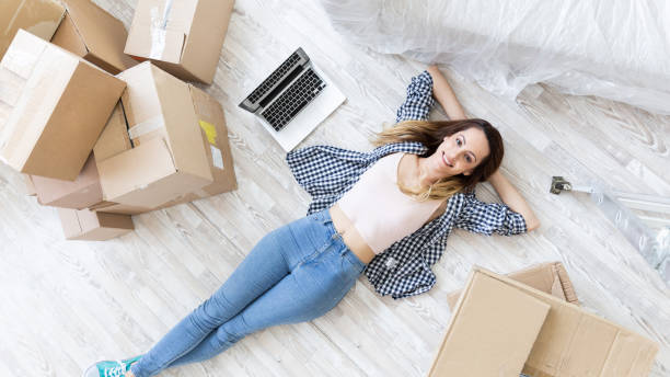 istock Young woman resting on floor in new home 1158199355