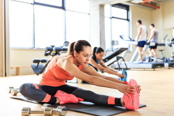 istock Young woman stretching in gym 1158200966