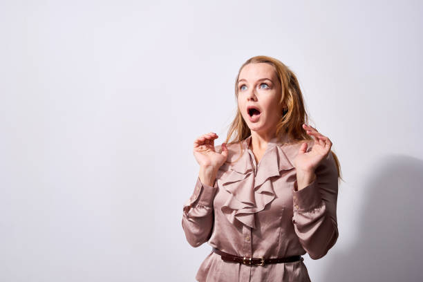 Scared young woman looking up speechlessly