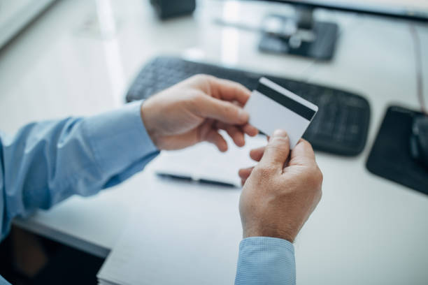 istock A businessman holds a credit card in his hand 1158201975