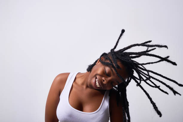 istock Smiling black woman shaking with dreadlocks 1158202213