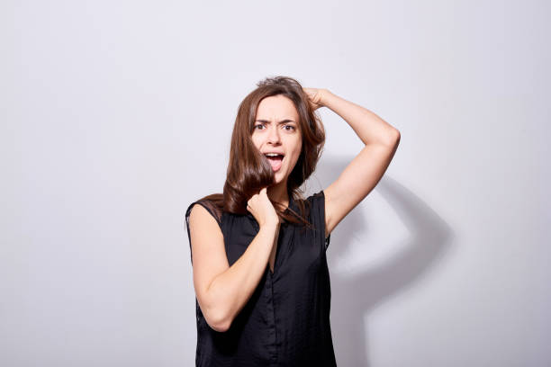 istock Young expressive brunette tangling hair 1158202392