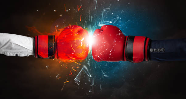 istock Fighting hands breaking glass with fire and water 1158205918