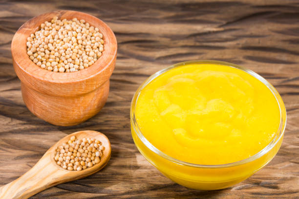 istock Mustard with seeds on the wooden background. 1158205988