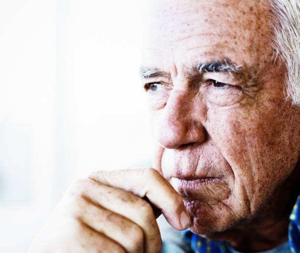 istock Handsome senior man looks thoughtful 1158206285