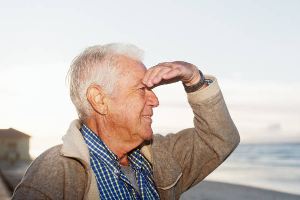 Attractive 75-year-old man looks out to sea.