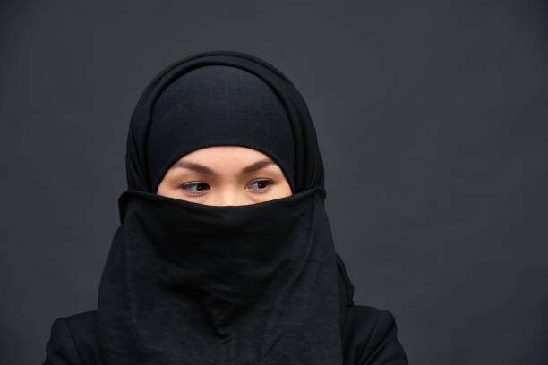 istock Young ethnic woman wearing black hijab 1158207312
