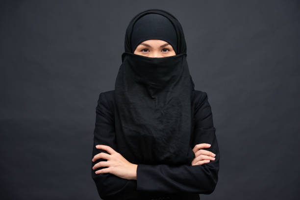 istock Confident elegant woman in black hijab 1158207318