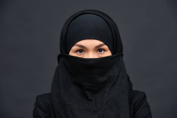 istock Covered ethnic woman in black hijab 1158207319