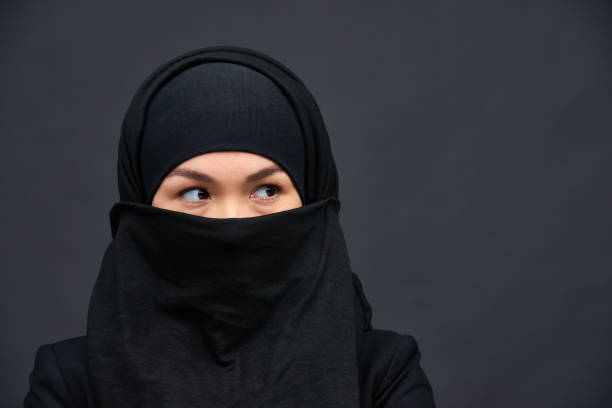 istock Covered ethnic woman in black hijab 1158207323