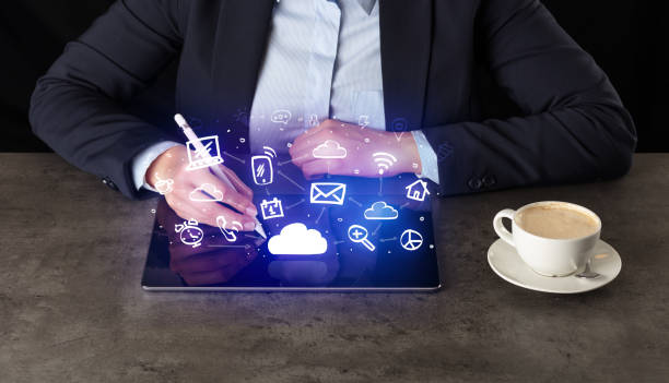istock Business woman working on tablet with application symbols above 1158208933