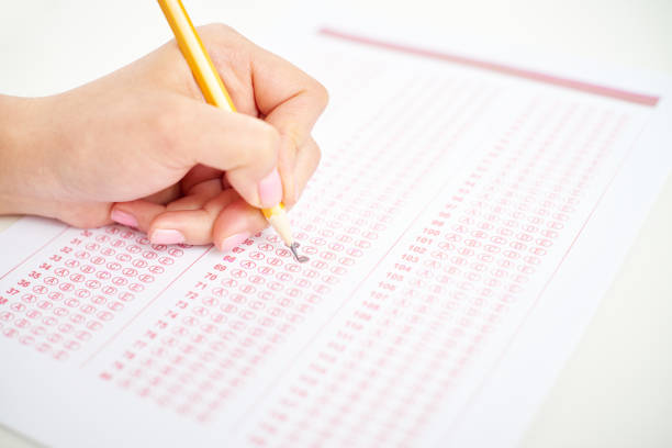 istock Crop woman doing test and picking answers 1158213733