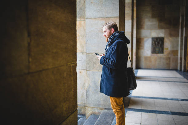 istock Ginger businessman texting outdoors on a snowy day 1158213869
