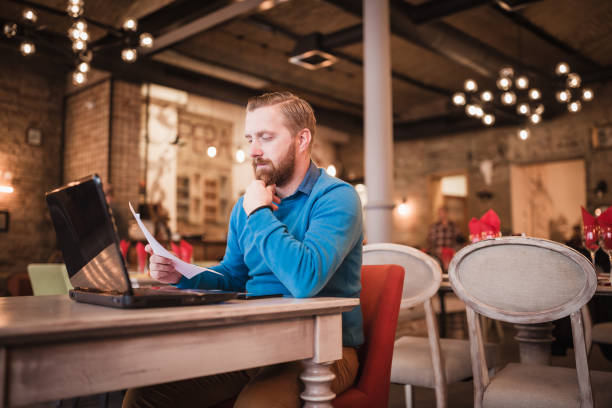 istock Young, redhead businessman, on coffee break working on laptop 1158213877
