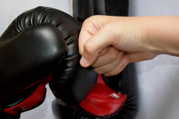 istock young hand against a boxing glove 1158215512